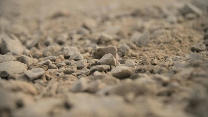 a close up of rocks and gravel with a blurry background