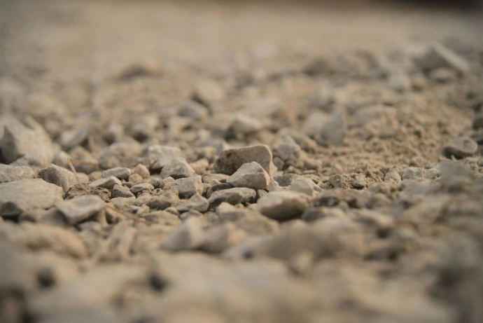 a close up of rocks and gravel with a blurry background